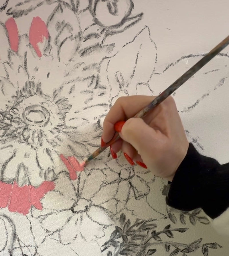 Hand painting a floral design with pink accents on a white background Joan Davis